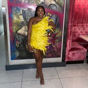 Super cute yellow with purple accent feather mini dress. Makes a statement.